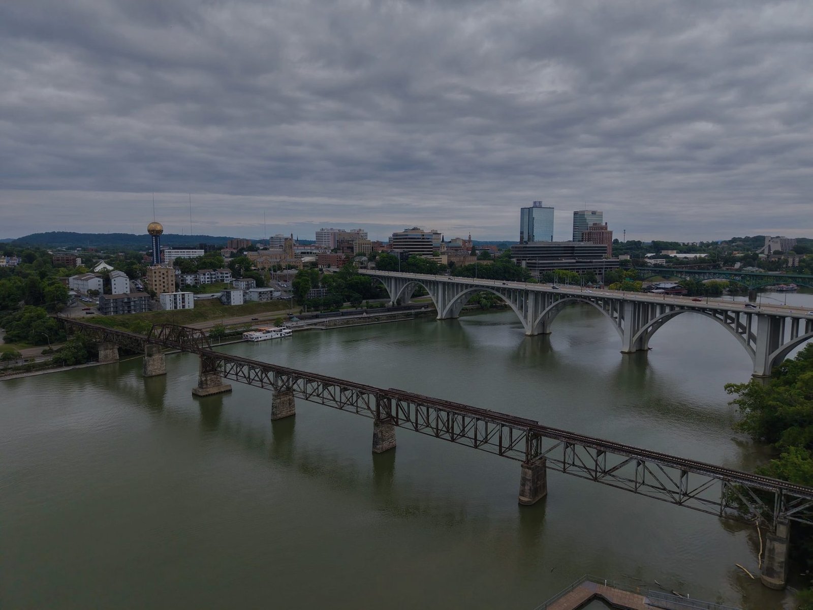 Aerial view of road and rail bridges crossing the Tennessee River at Knoxville under grey cloud