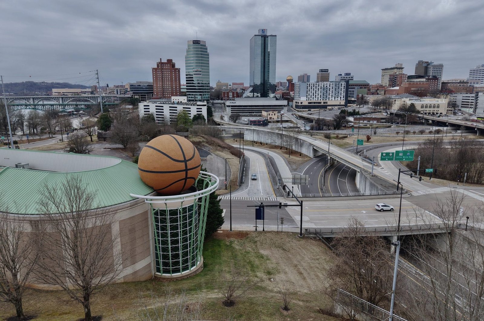 Highway ramps curving past downtown Knoxville on an overcast day